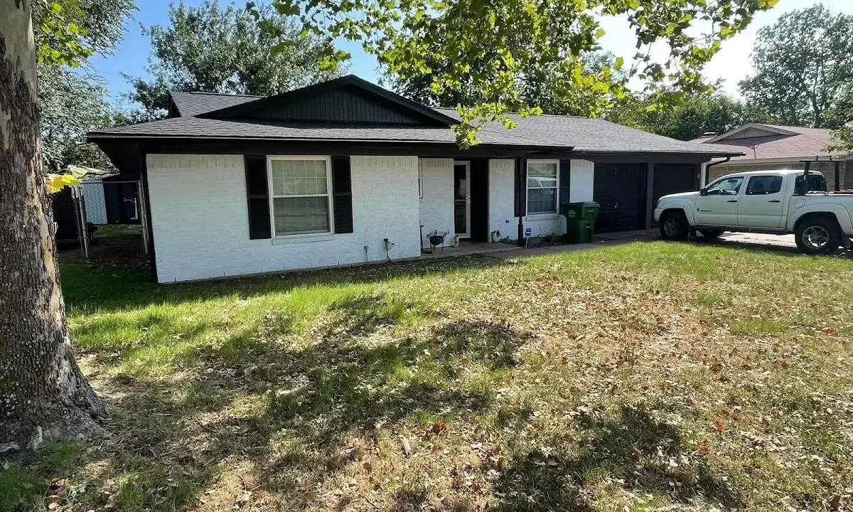Professional roofing crew working on a residential roof in North Kingstown